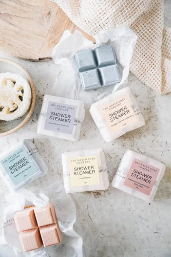 Shower steamers of all colours placed on marble table